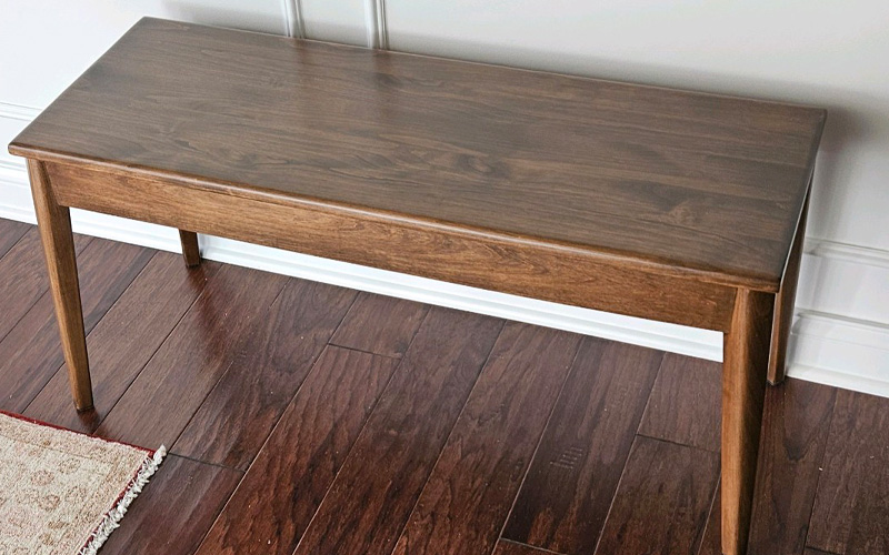 a wooden bench on a wood floor